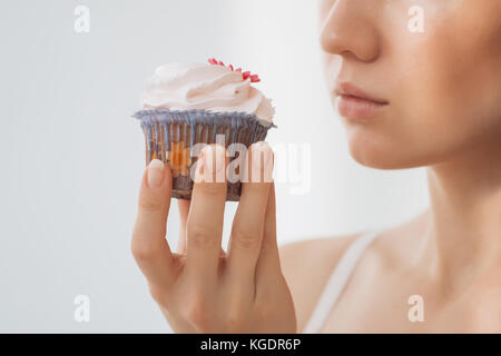 Woman wants to eat a cupcake Stock Photo