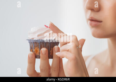 Woman wants to eat a cupcake Stock Photo