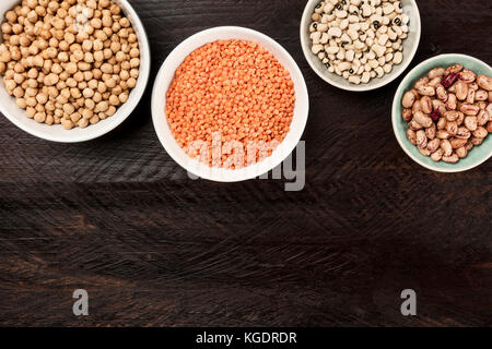Legumes on dark background, from above with copy space Stock Photo