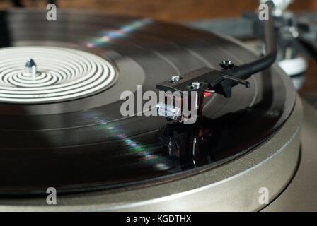 Moving magnet cartridge on the tonearm standing on a vinyl record Stock Photo