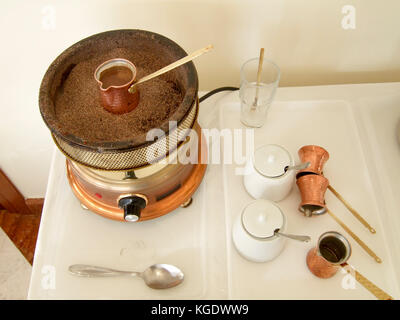 Greece, slow cooking Greek Coffee on an electric plate In other parts of the world it is known as Turkish Coffee Stock Photo