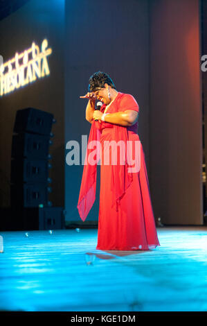 Gospel afro american mature famous singer performing during a night concert. Christmas event at Fiesole, Florence Italy Stock Photo