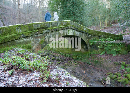 Sheffield, UK - Jan 2015: Two children playing on Packhorse Bridge over Tinker Brook on 18 Jan 2015 at Glen Howe park, near Wharncliffe Side Stock Photo