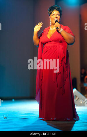 Gospel afro american mature famous singer performing during a night concert. Christmas event at Fiesole, Florence Italy Stock Photo