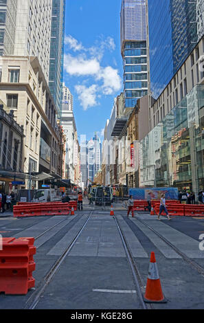 Construction work laying steel rail tracks along George Street in Sydney's CBD (central business district) for the 12km South East Light Rail route Stock Photo