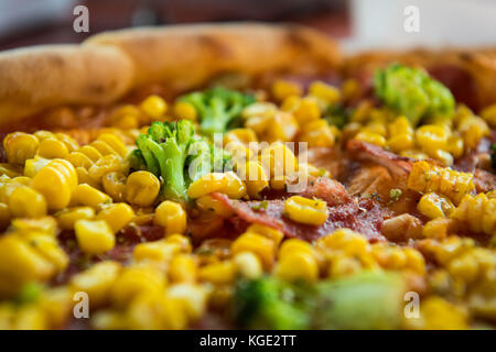 Pizza with salami, sweetcorn and broccoli Stock Photo