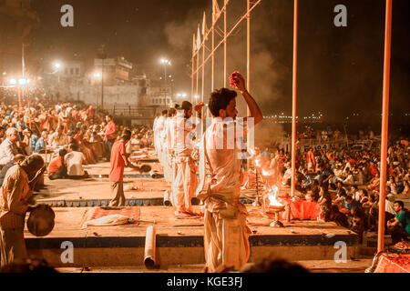 Ganga aarti puja ceremony performed by young priests at Dashashwamedh  Ghat Varanasi,Utter Pradesh, India. Selective focus is used. Stock Photo