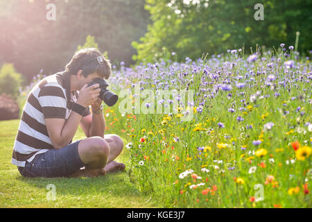 Young handsome caucasian photographer in botanic gardens Stock Photo