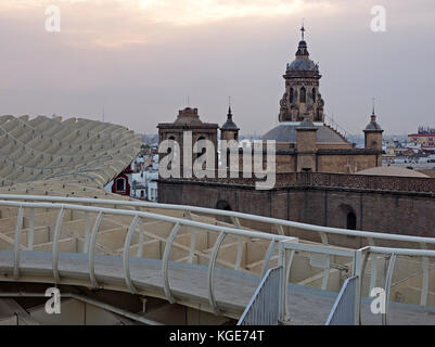 view across dusk skyline of Seville with domes and towers from the walkway on the  Metropol Parasol 'The Mushroom' Seville, Spain Stock Photo