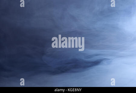 Abstract background of swirling blue smoke Stock Photo