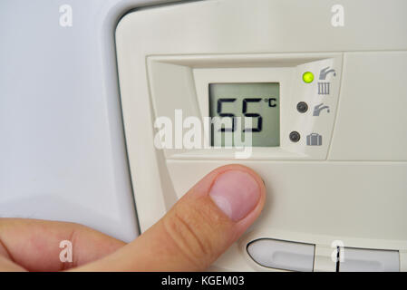 Setting the central heating level in gas furnace panel Stock Photo