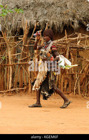 DIMEKA, OMO VALLEY, ETHIOPIA - JULY 27: Portrait of the woman from Hamer people  in transit to the local marketplace in Dimeka, Omo valley in July 27, Stock Photo