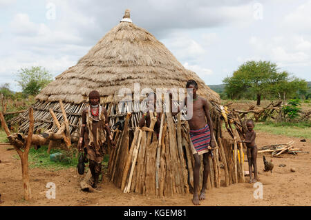 Tribal family standing in front of their hut. Birhor tribe. Keredari ...