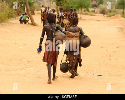 Local Ethiopian people coming back from the market from the Turmi village in the Omo valley in Ethiopia Stock Photo