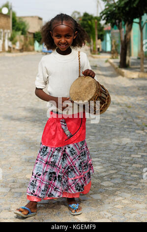 ADIGRAT, ETHIOPIA - AUGUST 22: Portrait of the young Ethiopian with the drum he is standing in the street during the local festival,  Adigrat in Augus Stock Photo