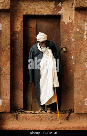 LALIBELA, ETHIOPIA - AUGUST 30: Ethiopian pilgrim at entering to the church carve in solid rock in Lalibela, Ethiopia in Lalibela in August 30, 2013 Stock Photo