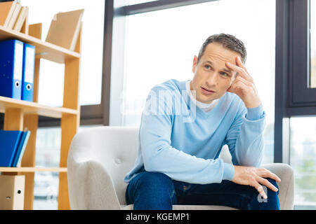 Cheerless adult man thinking about his life Stock Photo