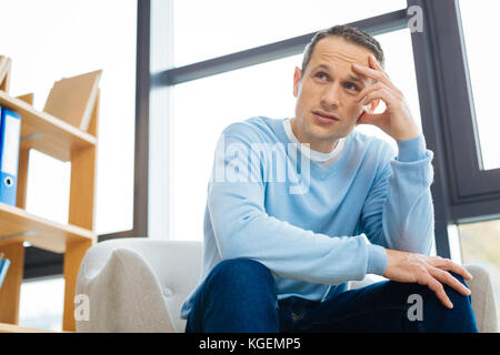 Unhappy handsome man feeling depressed Stock Photo