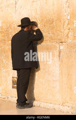 Israel The Holy Land Jerusalem Old City bearded religious Hassidic Jew Jewish man praying black suit hat beard The Western Wailing Wall Kotel Stock Photo