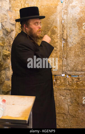 Israel The Holy Land Jerusalem Old City bearded religious Hassidic Jew Jewish man praying black suit hat beard The Western Wailing Wall Kotel Stock Photo