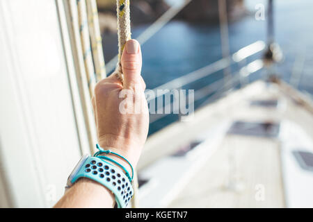 Woman hand on luxury yacht tackle. Stock Photo