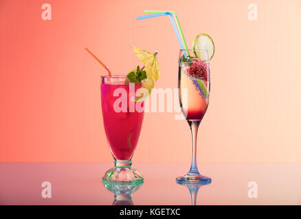 Refreshing cocktails on pastel orange background, studio shot with copy space
