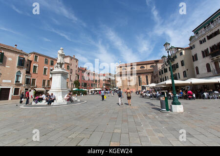 City of Venice Italy. The Campo Santo Stefano public square with the Niccolo Tommaseo monument in the foreground. Stock Photo