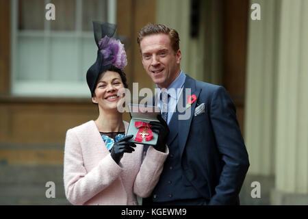 Actor Helen McCrory with husband Damian Lewis after she was awarded an OBE by Queen Elizabeth II at an Investiture ceremony at Buckingham Palace, London. Stock Photo