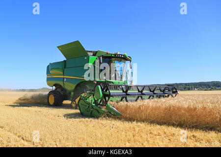 SALO, FINLAND - AUGUST 22, 2015: John Deere Combine s670i harvests barley at Puontin Peltopaivat Agricultural Harvesting and Cultivating Show. Stock Photo