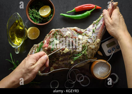 Raw lamb leg, marinated with herbs Stock Photo