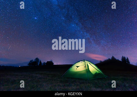 Green tent lighted from the inside Stock Photo