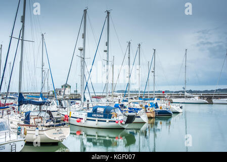 Luxury motor and sailing boats moored for winter in the marina harbour of Doc Fictoria (Dock Victoria) at Caernarfon, Wales, UK. Stock Photo