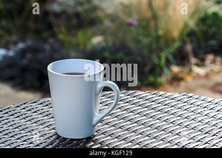 Mug coffee garden rattan table relax break Stock Photo