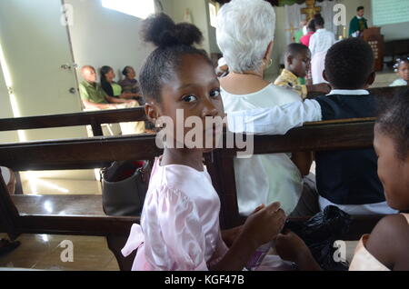 Seaford Town, Jamaica. 22nd Oct, 2017. A girl from Seaford Town, a Jamaican community founded by German migrants, drinking water during mass in Seaford Town, Jamaica, 22 October 2017. Seaford Town was built by German migrants. Credit: Georg Ismar/dpa/Alamy Live News Stock Photo