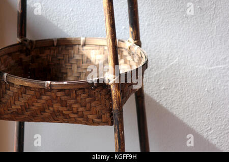 empty wicker basket on cement wall background Stock Photo
