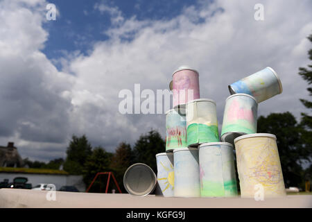 kids throwing a ball at cans Stock Photo