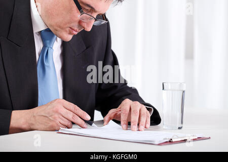 Senior businessman concentrate reading and  checking contract Stock Photo