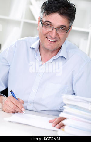 Smiling senior professor review tests in his office Stock Photo