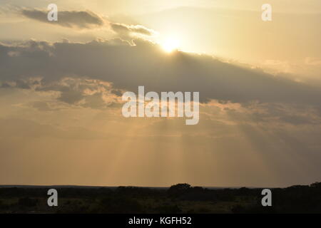 Bright Sun rays Shining though Clouds Stock Photo