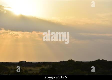 Bright Sun rays Shining though Clouds Stock Photo