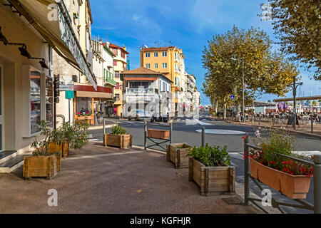 Golfe-Juan, France - November 03, 2017: day view of Quai Tabarly with tourists in cafe in low season on the Golfe-Juan quay, Cote d'Azur, Provence, Fr Stock Photo