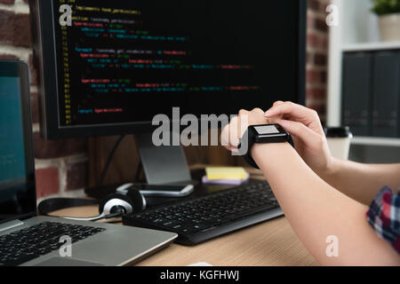 closeup photo of company office worker woman using mobile smartwatch work with blank screen. Stock Photo
