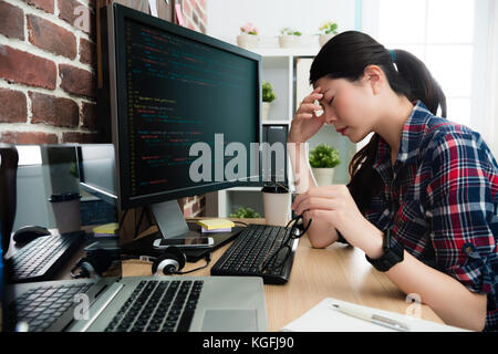 elegant beauty female programmer looking at computer working long time feeling tired and getting headache take off glasses resting. Stock Photo