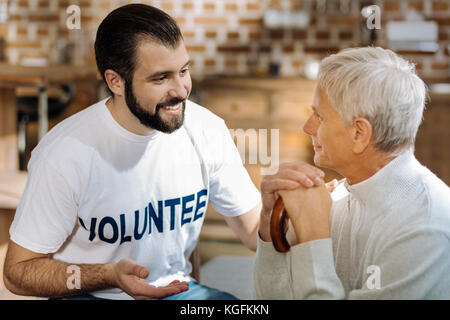 Elderly man having a pleasant conversation with his social worker Stock Photo