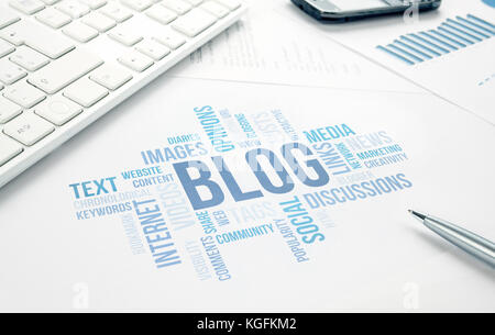 Blog concept word cloud chart print document, keyboard, pen and smartphone. Stock Photo