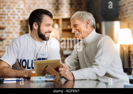 Two man laughing while looking at the photo Stock Photo