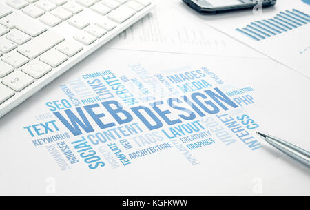 Web Design business concept word cloud print document, keyboard, pen and smartphone, keyboard, pen and smartphone. Blue toned. Stock Photo