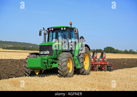 SALO, FINLAND - AUGUST 21, 2015: Unnamed farmer operates John Deere 6630 tractor and Agrolux plow on field at setting up of Puontin Peltopaivat Agricu Stock Photo