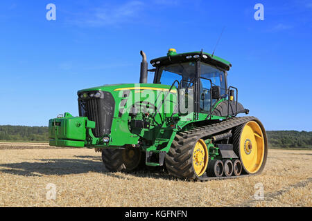 SALO, FINLAND - AUGUST 21, 2015: Unnamed farmer operates John Deere 8345RT tracked tractor on field at setting up of Puontin Peltopaivat Agricultural  Stock Photo