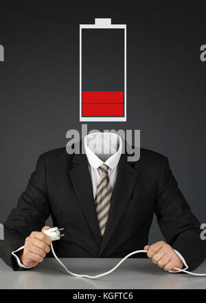 man with battery head and plug, charge you mind concept Stock Photo